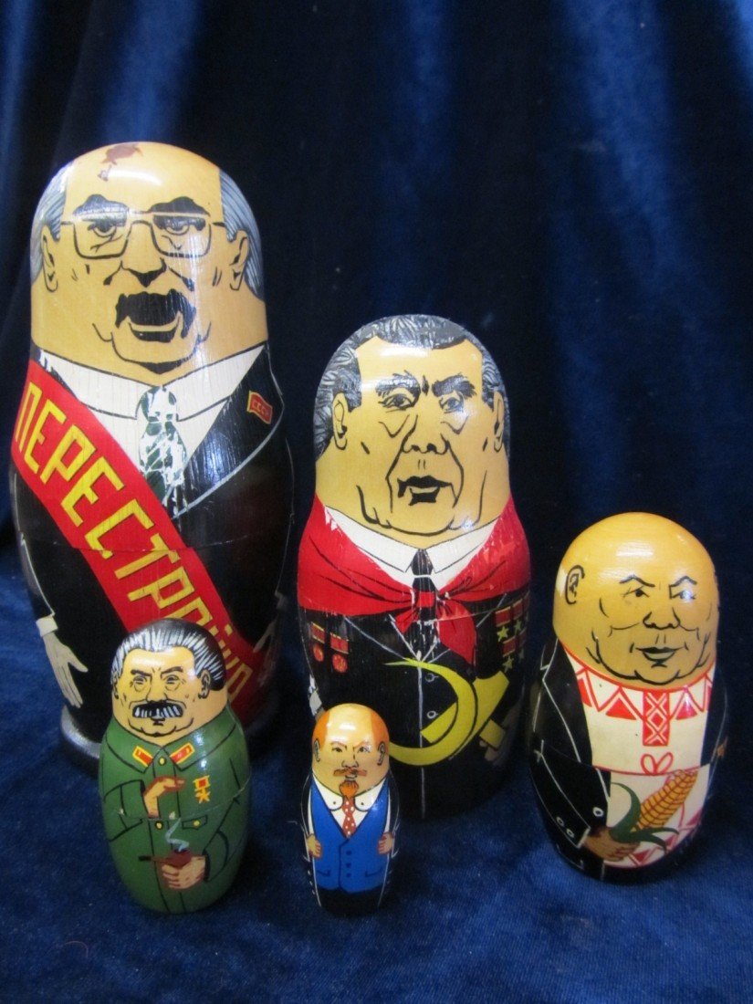RUSSIAN NESTING CUPS: RUSSIAN NESTING CUPS APPROX 4'' AT THE TALLEST X 3'' WIDE AT THE TALLEST. EACH FIGURINE DECREASES IN SIZE BY A SCALE OF APPROX. 2''.