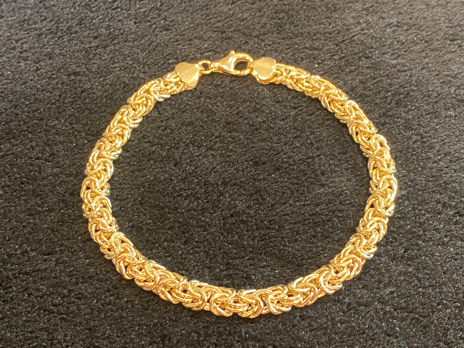 Yellow Gold Byzantine Bracelet Over 925 Sterling Silver: Yellow Gold Byzantine Bracelet Over 925 Sterling Silver. Measures approximately 1/4 of an inch in width and has a lobster claw claps. Size 7.5in long. Metal Weight5.81 g. Ships from Austin, TX.