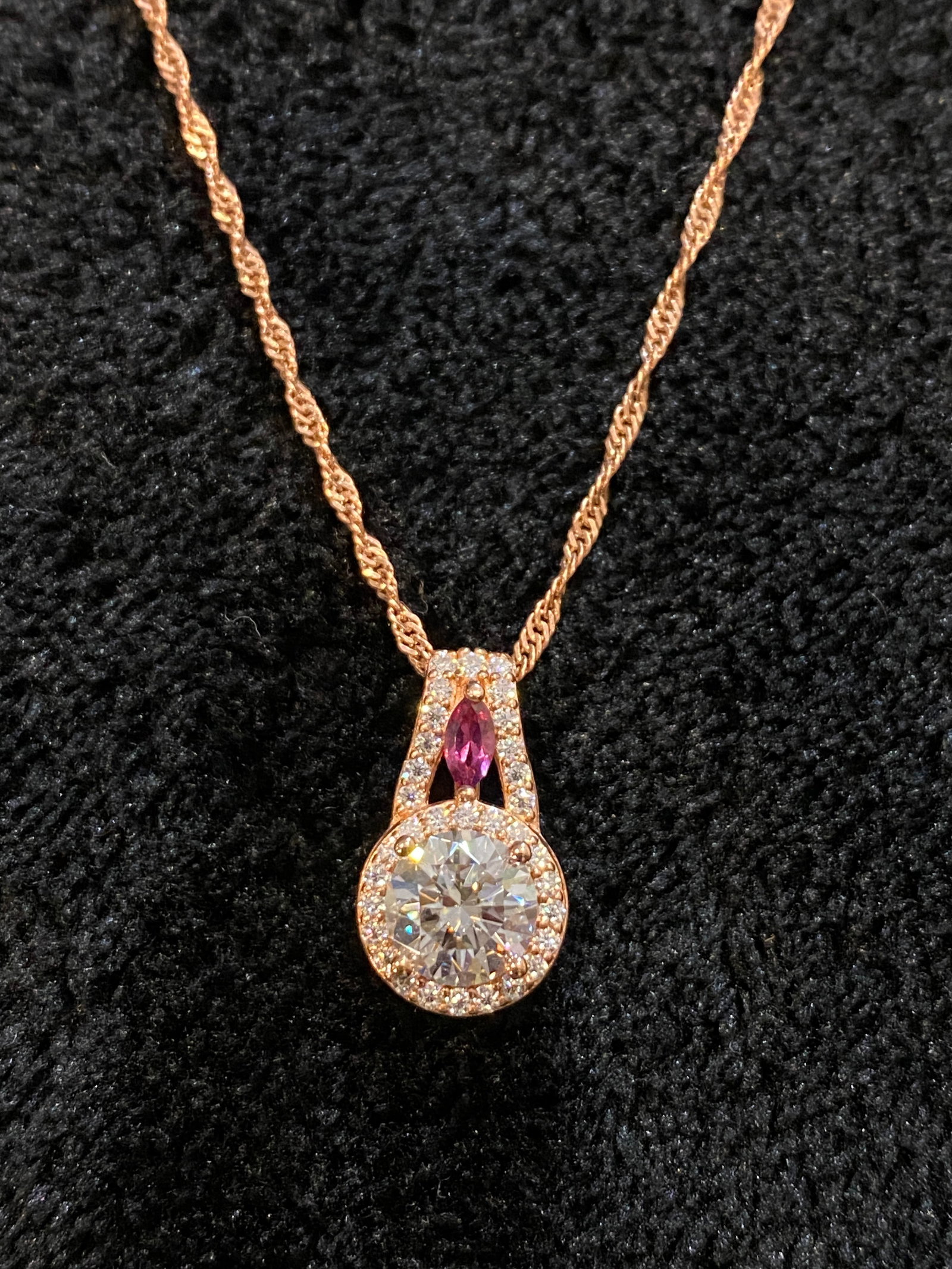 Moissanite Fire diamond equivalent weight round and .12ctw marquise cut grape color garnet, rose: Moissanite Fire 1.84ctw diamond equivalent weight round and .12ctw marquise cut grape color garnet, rose gold tone over silver pendant with 20 inch Singapore chain. Measures approximately 11/16" L x 5