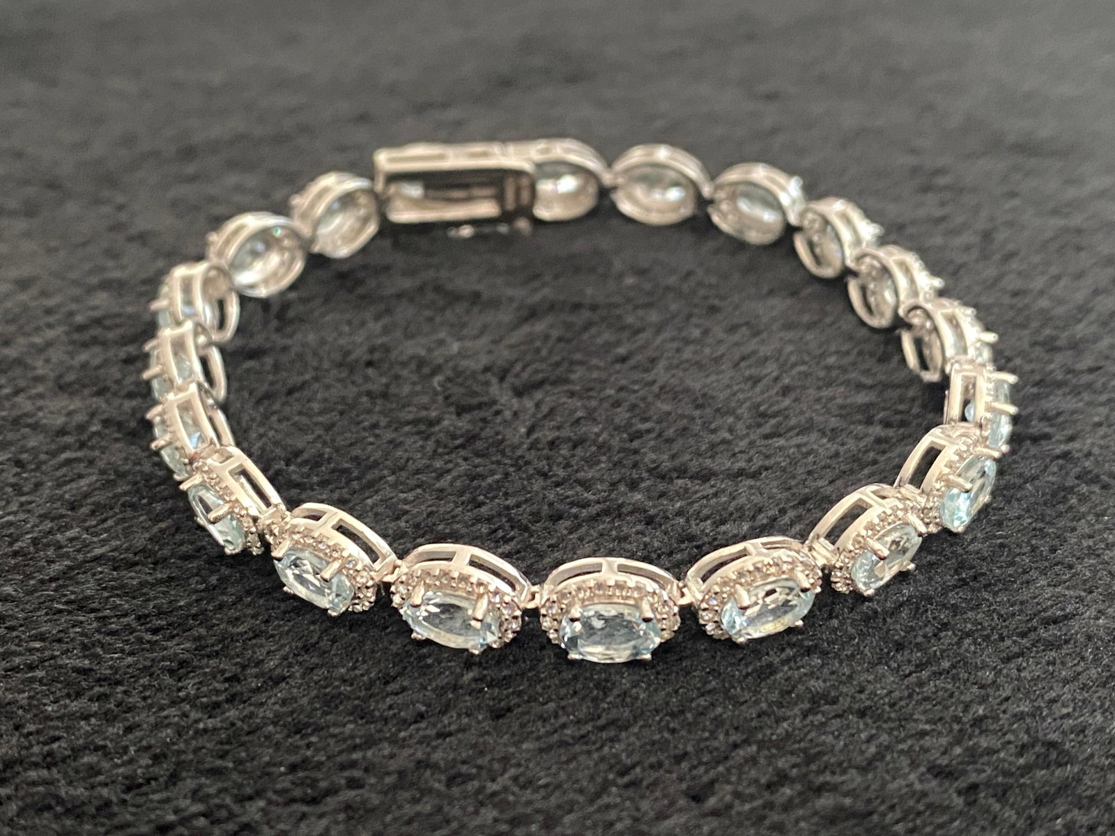 Blue Aquamarine Rhodium Over Sterling Silver Tennis Bracelet 7.75ctw: Blue Aquamarine Rhodium Over Sterling Silver Tennis Bracelet 7.75ctw. 6.00ctw Oval Aquamarine With 1.75ctw Round White Zircon Rhodium Over Sterling Silver Tennis Bracelet. Measures Approximately 0.25"