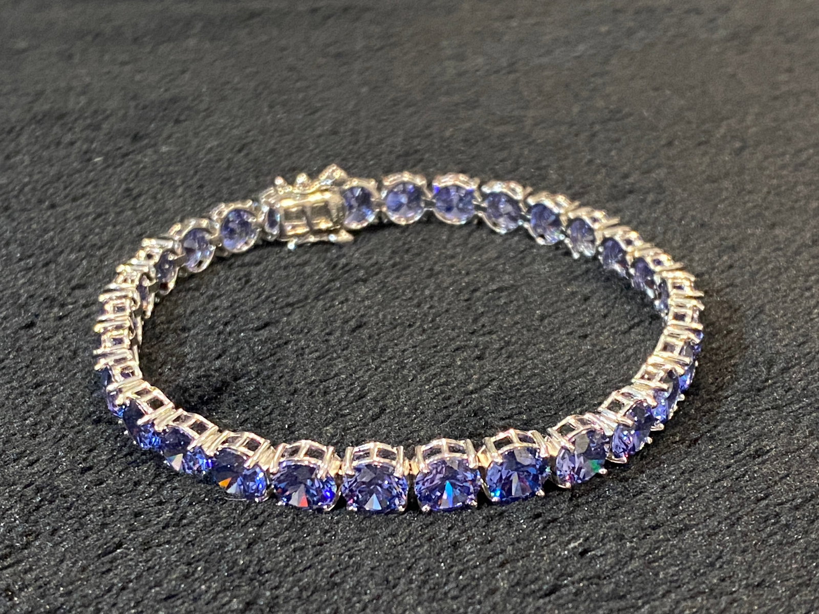 Blue Tanzanite Rhodium Over Sterling Silver Bracelet: Blue Tanzanite Rhodium Over Sterling Silver Bracelet . Size 7.5in long. Marquise Tanzanite Rhodium Over Sterling Silver Bracelet. Measures Approximately .31"W. Box Clasp. Metal Weight 8.8 g.. Ships fr