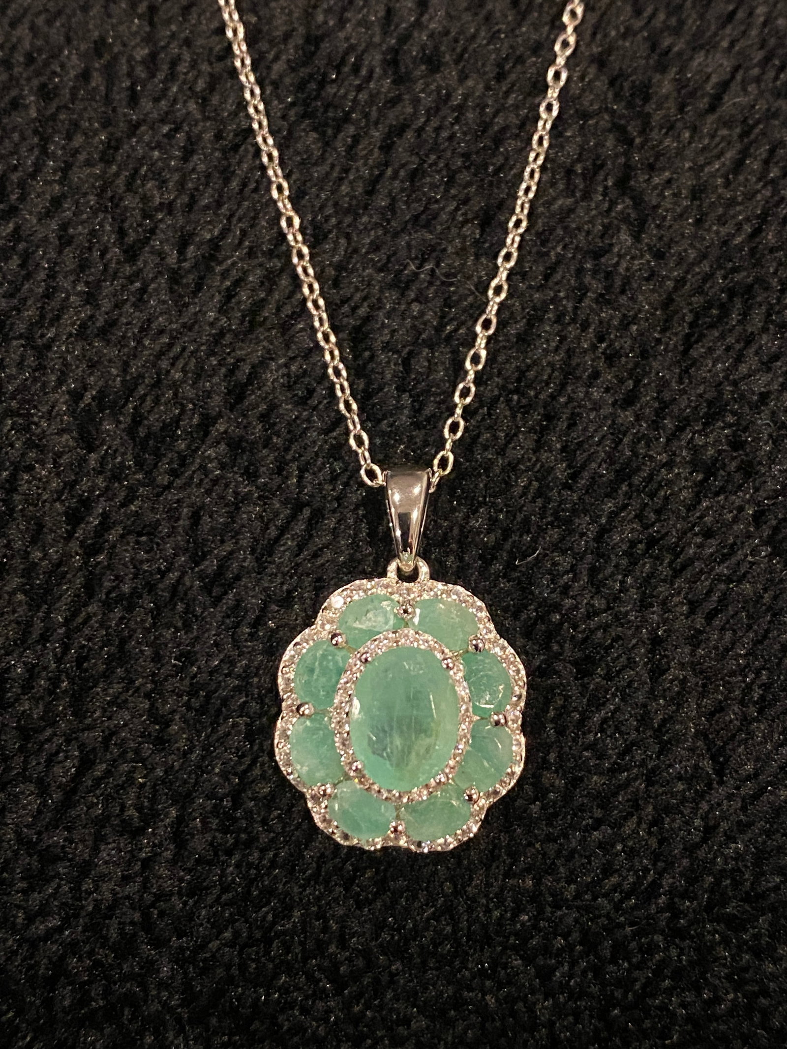 Green Emerald Rhodium Over Sterling Silver Pendant With Chain 3.35ctw: Green Emerald Rhodium Over Sterling Silver Pendant With Chain 3.35ctw. 2.64ctw oval emerald with .71ctw round white zircon rhodium over sterling silver pendant with 18" chain. Measures approximately 5