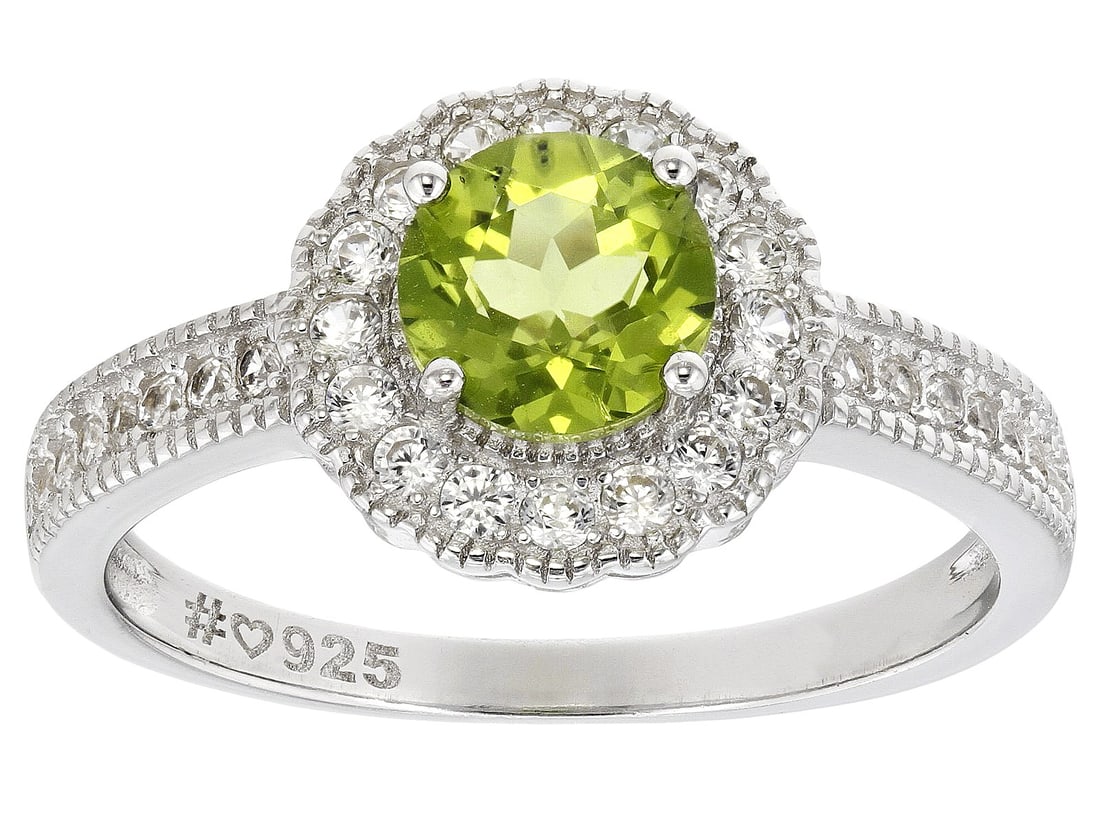 Green Peridot Rhodium Over Sterling Silver Ring 1.19ctw: Green Peridot Rhodium Over Sterling Silver Ring 1.19ctw. Size 9. 0.80ct Round Manchurian Peridot With 0.39ctw Round White Zircon Rhodium Over Sterling Silver Ring. Measures Approximately 0.80"L x 0.42