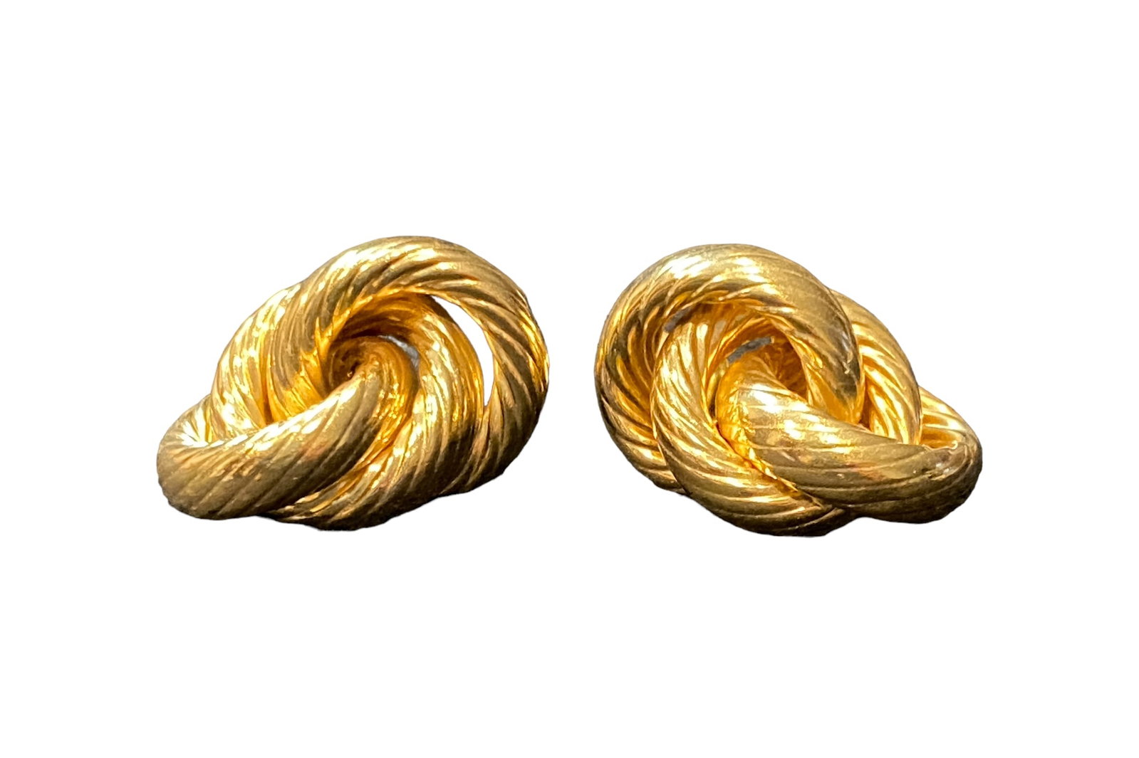 14 Karat Gold Triple Loop Earrings, Pair: These 14 karat yellow gold earrings feature 3 hollow gold loops which measure approximately 15 mm across and 5 mm wide. Each of the loops has a swirled line design. They are completed with a gold post