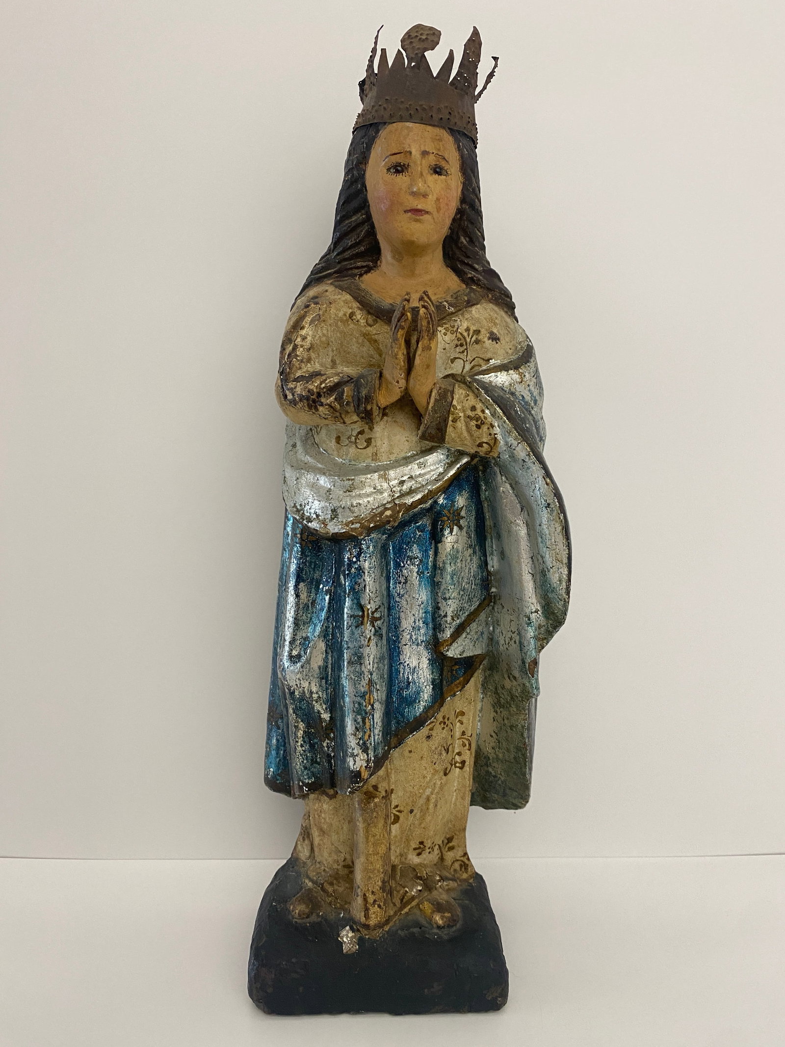 Praying Madonna / Saintess w/ Blue Cape: Shipping from Austin, TX Dimensions: 14.5 x 4.5 in Reminiscent of traditional Catholic statuary, representing the Virgin Mary in a posture of prayer and wearing a crown, which signifies her as the Que