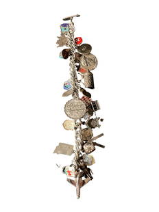 Sterling Silver Charm Bracelet with Eclectic Travel Charms: Sterling silver bracelet featuring a variety of intricate charms, including cultural and landmark motifs from all over the world. L: 7 1/2" Wt: 24g. Ships from Los Angeles, CA.