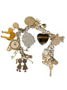 14K Gold Charm Bracelet with Assorted Charms: Charm bracelet in 14K gold featuring a mix of unique charms including animals, a key, and decorative pendants, the ladybug, "Diana" and angel have all been stamped with the 14K symbol. The main bracel