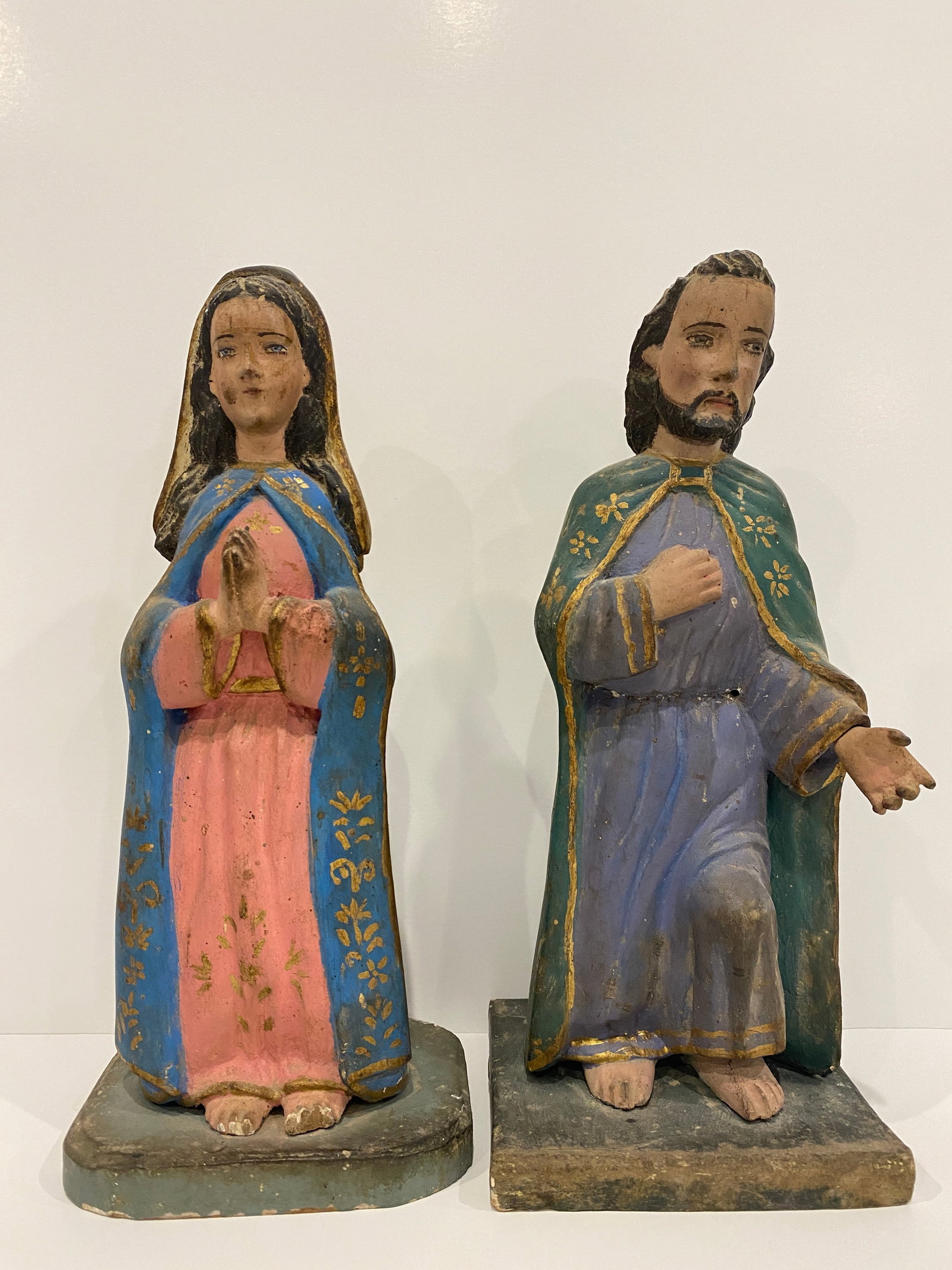 Joseph & Mary Wooden Statue Set: Hand-painted Mary and Joseph statue set. Aged, wooden, and rich in color, these figures offer a timeless spiritual charm for collectors and believers alike. Shipping from Austin, TX. Dimensions: 10.5 