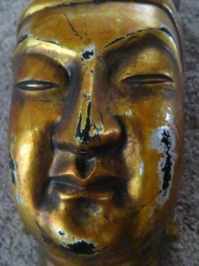 19TH CENTURY GILDED GOLD ON WOOD BUDDAH MASK NEPAL: 19TH CENTURY GILDED GOLD ON WOOD HAND CARVED BUDDAH MASK NEPAL BEAUTIFUL GOLD ON CARVED WOOD BUDDAH WALL HANGING MASK SIGNED . DIMENSIONS.16 INCHES HIGH X 10 INCHES WIDE.6 INCHES DEEP.