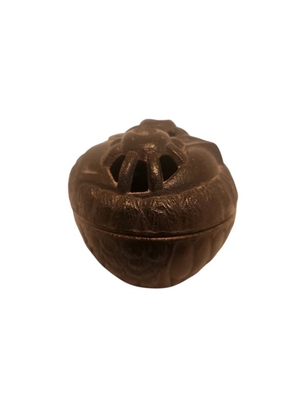 Asian Cast Iron Incense Burner: Asian Cast Iron Incense Burner A round Asian cast iron incense burner with a detailed floral motif and openwork lid for dispersing fragrance. Dimensions: 3.2 x 3 in Shipping from Indio, CA.