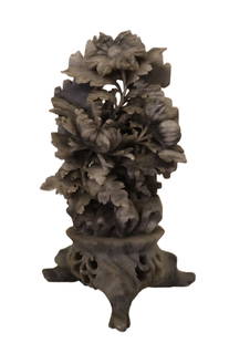 Hard Stone Asian Carving: Hard Stone Asian Carving A beautifully detailed stone featuring an intricately carved floral design. This piece showcases lifelike petals, leaves, and flower buds, with a decorative cutout base that