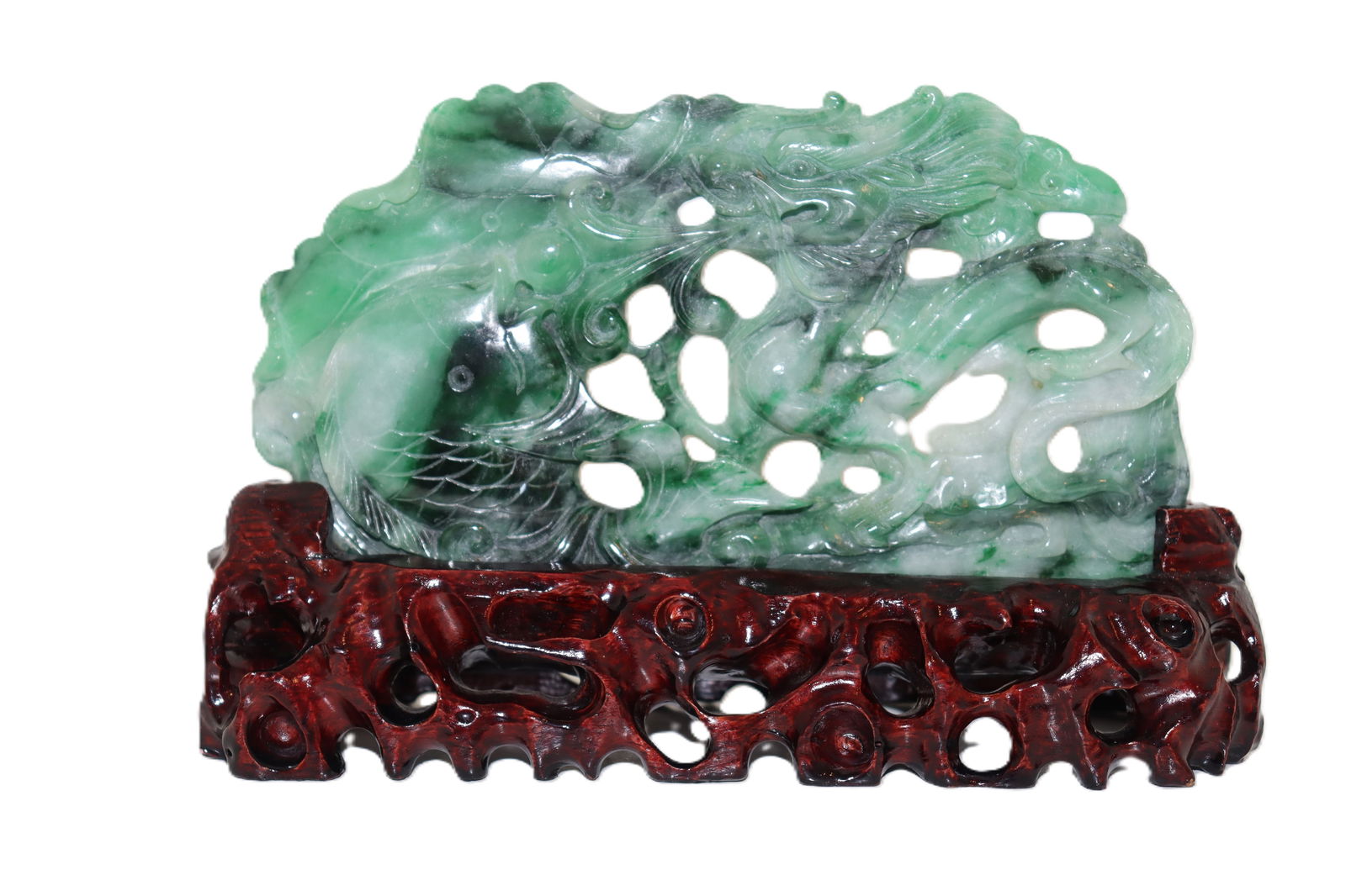 Green Jadeite Dragon and Fish Carving on Ornate Stand: Green Jadeite Dragon and Fish Carving on Ornate Stand This remarkable jadeite carving features a dynamic scene with a dragon and fish, expertly crafted with intricate detailing. The vibrant green tone