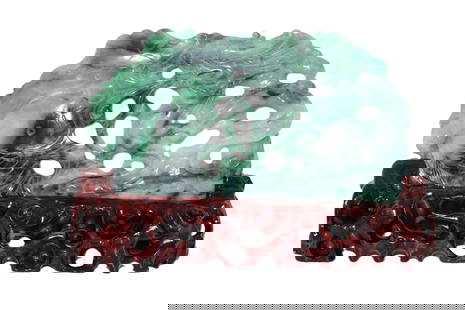 Green Jadeite Dragon and Fish Carving on Ornate Stand: Green Jadeite Dragon and Fish Carving on Ornate Stand This remarkable jadeite carving features a dynamic scene with a dragon and fish, expertly crafted with intricate detailing. The vibrant green