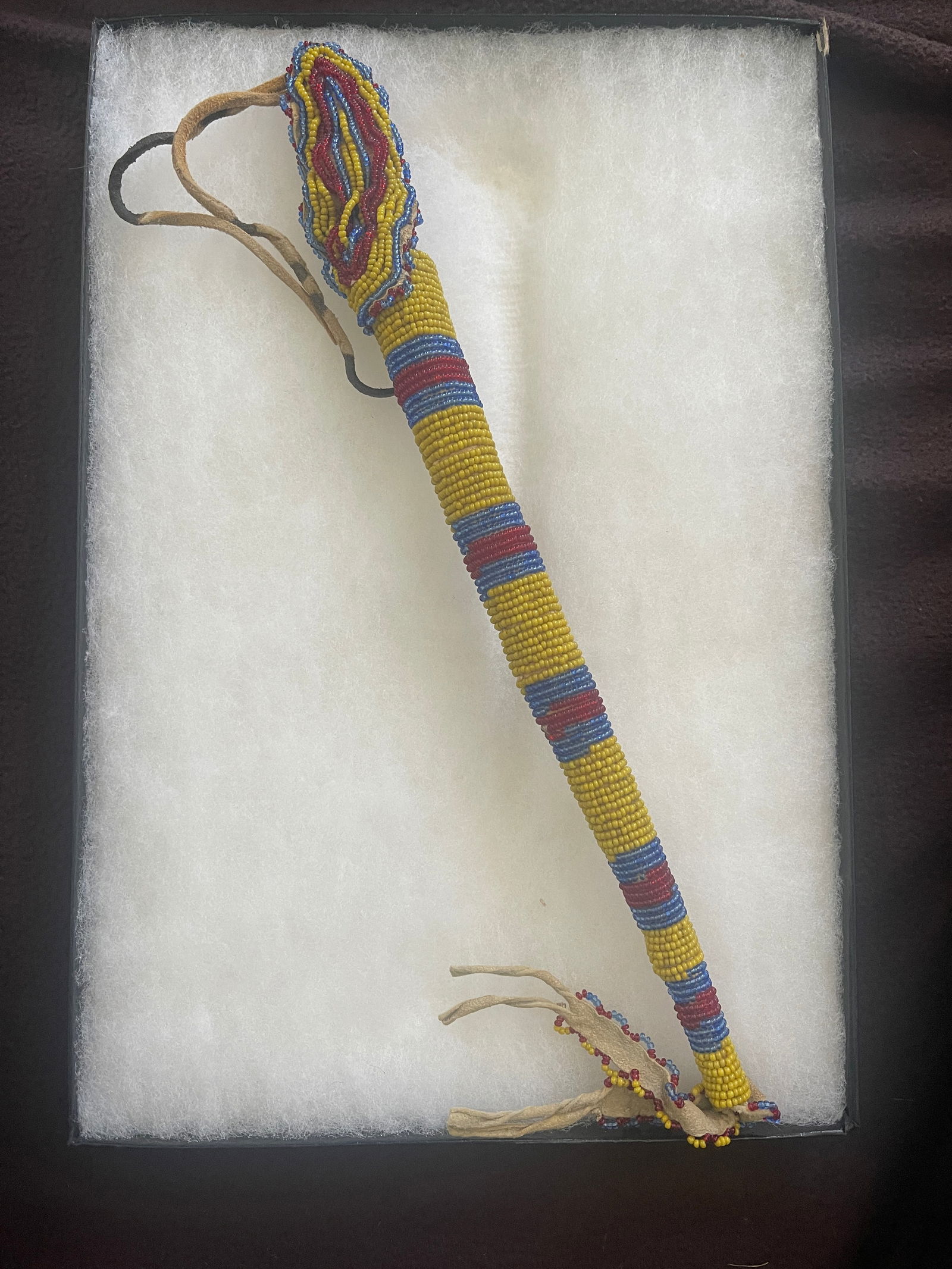Native American Handcrafted Awl Case: Native American Awl Case Periwinkle, Greasy Yellow, Cobalt Blue, and Red seed beads to decorate this Awl Case. He or she wrapped the beads around the case. At the top, the crafter added a beaded loop