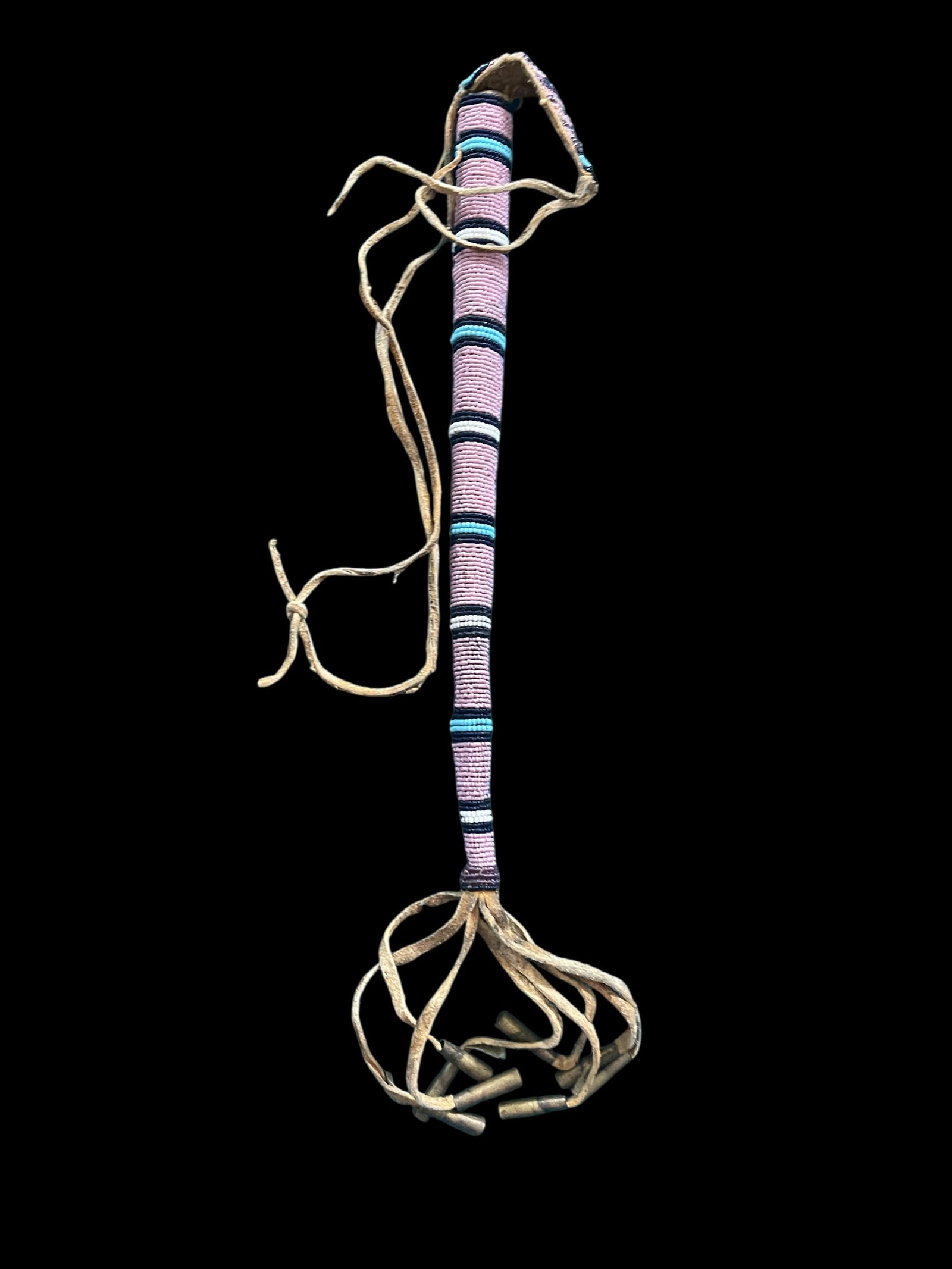 Native American Handcrafted Awl Case: The lot features a beaded hide awl case dating to the early 1900's from American Indians .The piece shows a typical awl case pattern with parfleche rawhide cone shape, wrapped in Indian tanned buckski