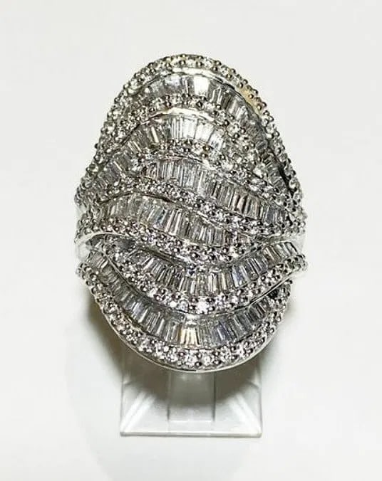 Bold 18k White Gold Diamond Dome Cocktail Ring 2.50ctw Baguette & Round Cut 15 Grams Size 7: Description: A substantial and dazzling 18k white gold cocktail ring featuring a brilliant 2.50 carat total weight display of natural diamonds. This striking dome ring immediately draws the eye,