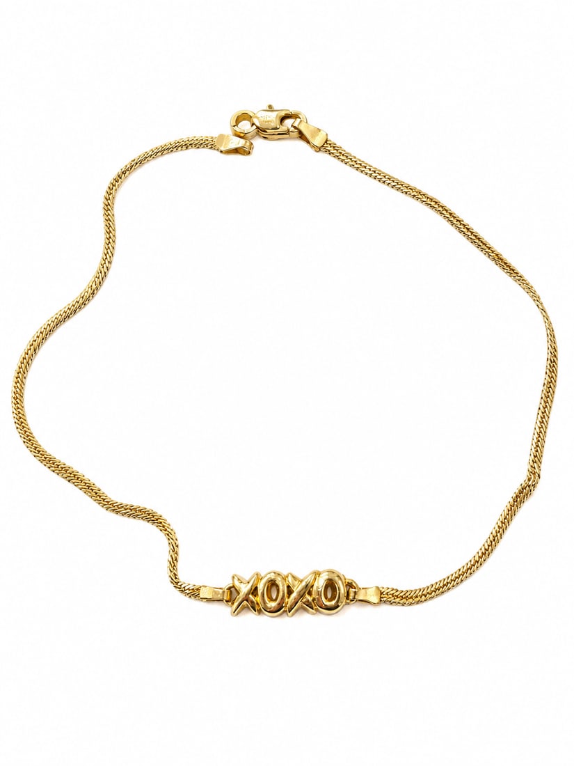 Gold-Tone XOXO Chain Bracelet: Gold-tone chain bracelet featuring a polished “XOXO” centerpiece and lobster clasp closure. Ships from Newport Beach, CA. Proceeds go to Hoag Hospital Charitable Foundation