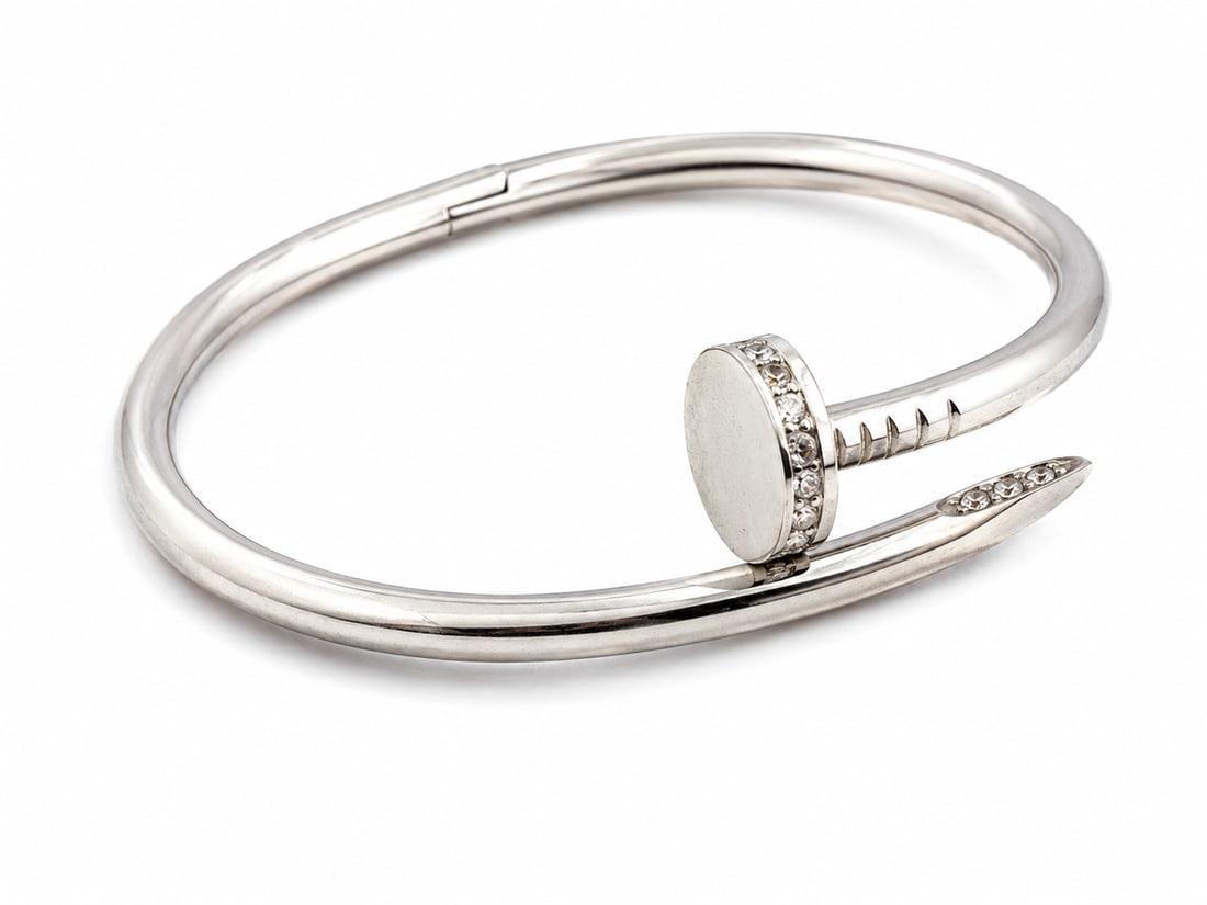 Silver-Tone Nail Bangle Bracelet with Crystal Accents: Silver-tone nail-inspired bangle bracelet featuring crystal accents and a hinged clasp. Ships from Newport Beach, CA. Proceeds go to Hoag Hospital Charitable Foundation