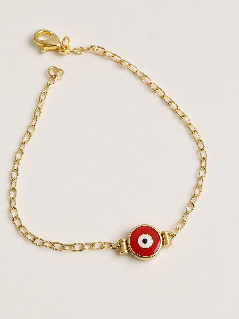 Gold Tone Red Evil Eye Link Bracelet: Gold-tone link bracelet featuring a red evil eye center charm with lobster clasp and extender chain.Ships from Newport Beach, CA.Proceeds go to Hoag Hospital Charitable Foundation.