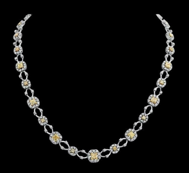 JB Diamonds 12.16ctw Diamond Love Necklace in 18K Two-Tone Gold: Description: An exquisite 3D flower square eternity design, masterfully crafted to showcase a stunning contrast of white and fancy yellow diamonds. Arrives in a signature red JB Diamonds gift box. Bra