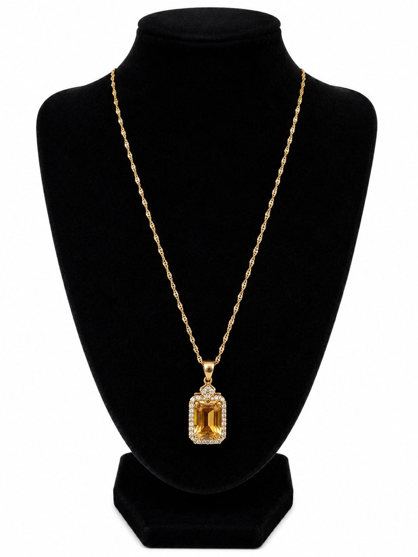 Gold Necklace with Yellow Stone Pendant: Gold necklace featuring a rectangular yellow faceted stone pendant surrounded by clear accent stones and decorative detailing. Ships from Newport Beach, CA.