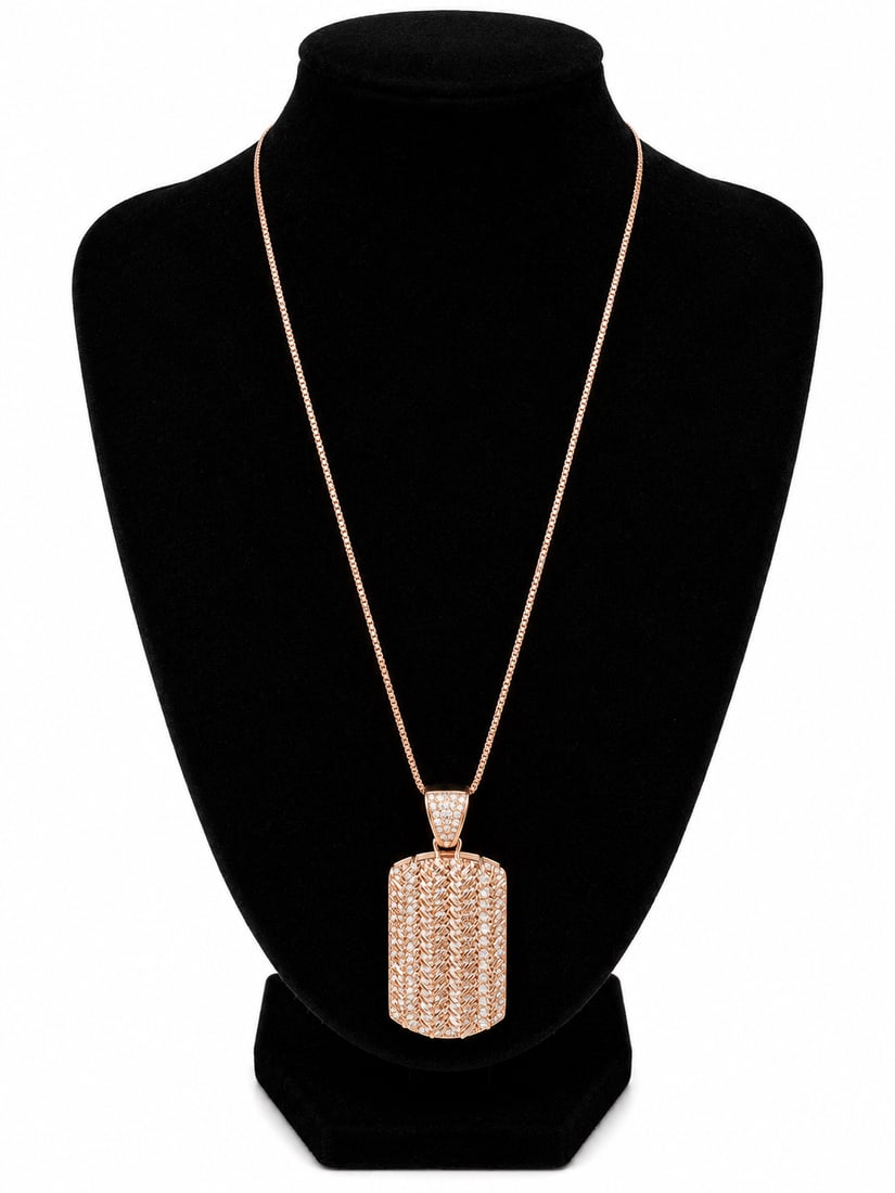 Rose Gold Dog Tag Pendant Necklace: Rose gold necklace featuring a rectangular dog tag-style pendant with textured detailing and clear stone accents throughout the pendant and bail. Ships from Newport Beach, CA.