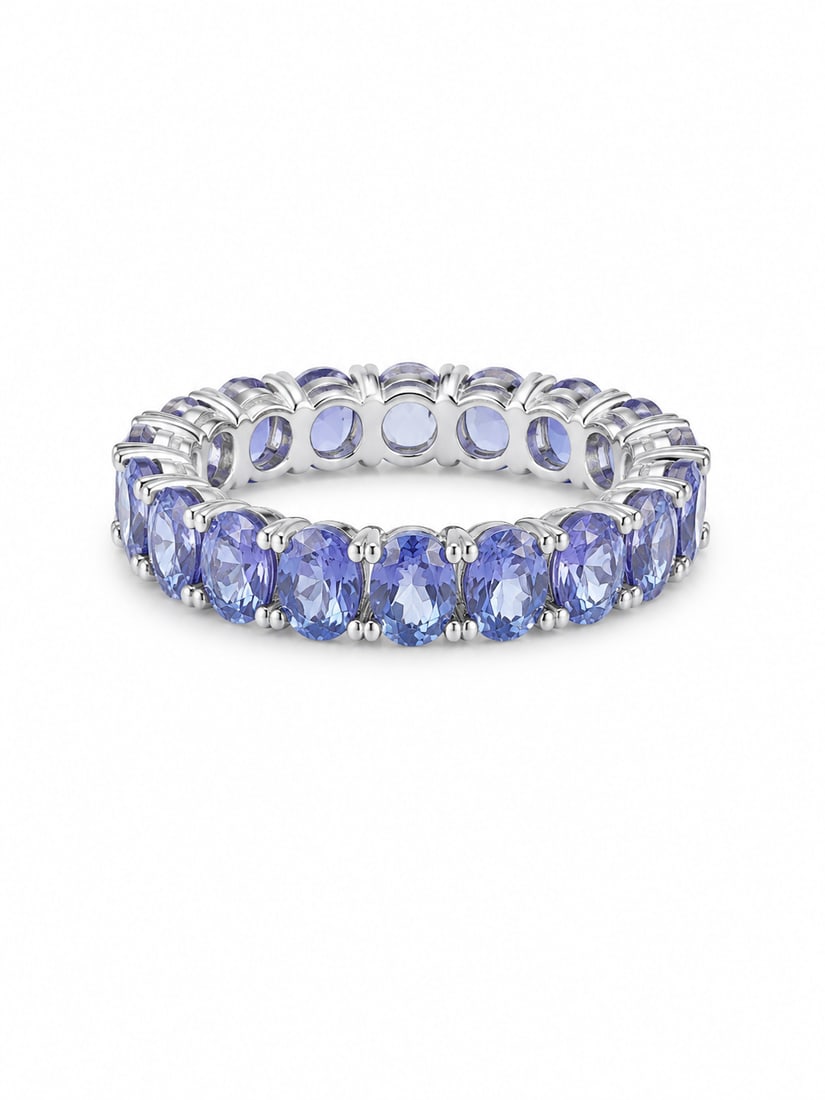 Sterling Eternity Style Ring with Oval Lavender Blue Stones: Silver ring featuring a continuous row of oval lavender-blue stones set around the band in an eternity style design. Size 9. Ships from Newport Beach, CA.