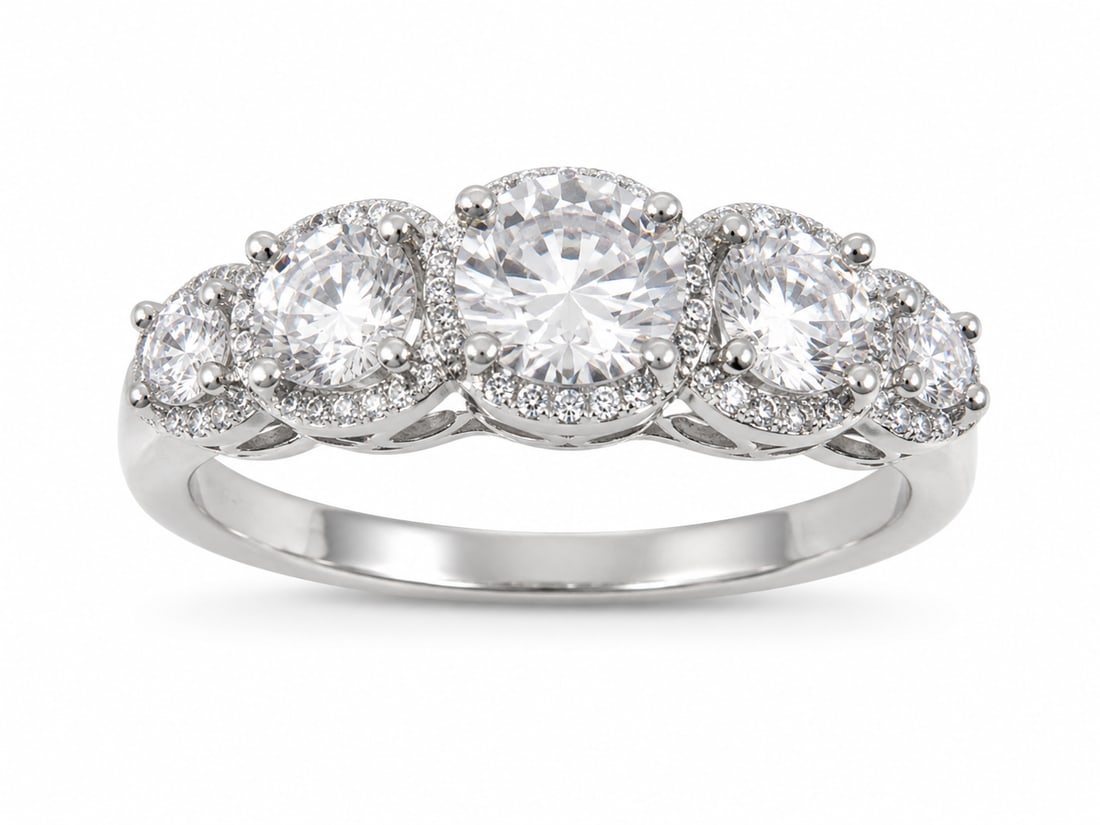 Silver Five-Stone Ring with Moissanite Round Center Stones & Cubic Zirconia Accents: Silver ring featuring five graduated round clear stones with a moissanite appearance, each framed by smaller clear cubic zirconia accents in a scalloped halo setting.Ships from Newport Beach, CA.