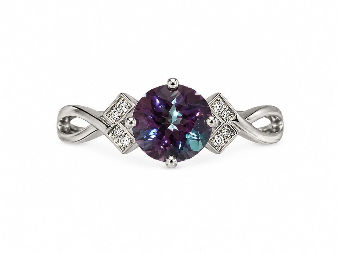 Silver Mystic Topaz & Clear Stone Infinity Ring: Silver ring featuring a large round-cut mystic topaz center stone displaying rich purple, blue, and teal hues. Clear accent stones frame each side of the center setting, while the polished band forms 