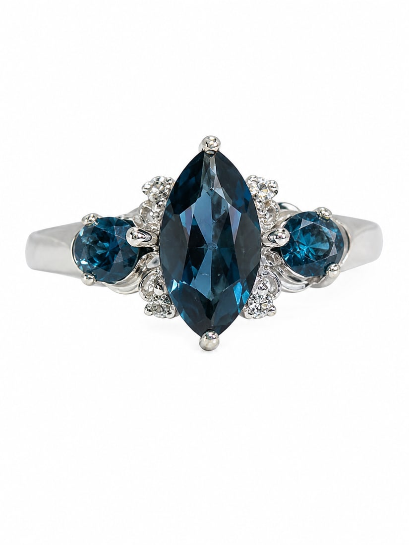 Blue Topaz & White Stone 925 Silver Three-Stone Ring: 925 silver ring featuring a large marquise-cut deep blue topaz center stone, flanked by two round-cut blue topaz stones and smaller white stone accents. The three stone arrangement creates an elegant,
