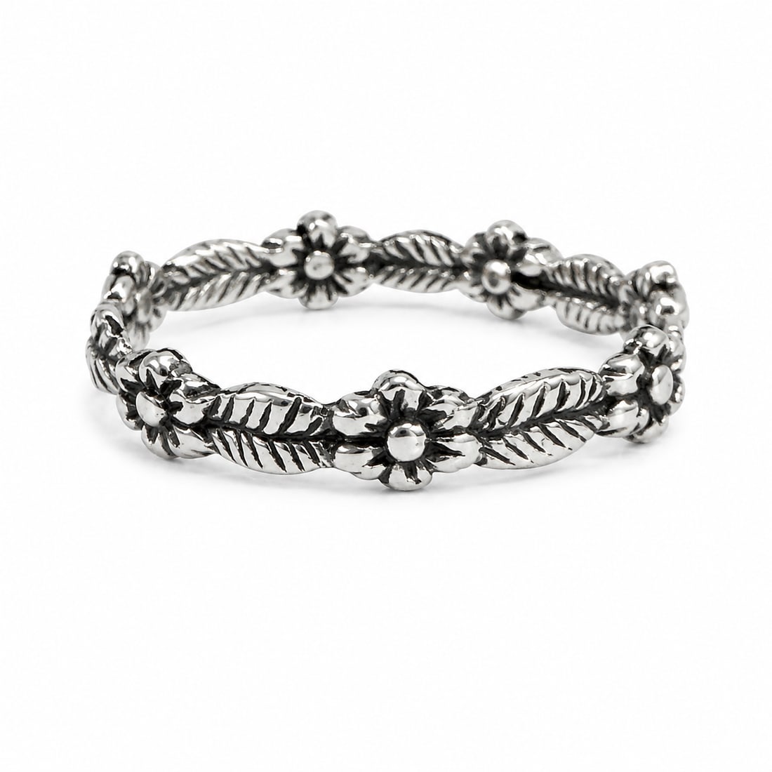 Sterling Silver Floral Leaf Vine Band Ring: Sterling silver ring featuring a continuous floral and leaf vine design with sculpted blossoms and textured foliage wrapping around the band. Darkened recessed detailing enhances the botanical