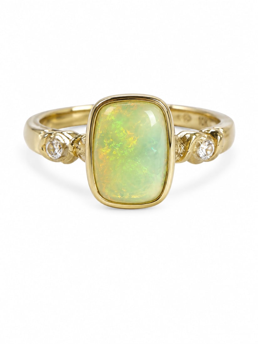 Opal Rectangular Cabochon Sterling Silver Gold Ring: Gold-finished sterling silver ring featuring a rectangular opal cabochon with luminous green, yellow, and golden flashes. Round white crystal accents sit on each side, complemented by sculpted