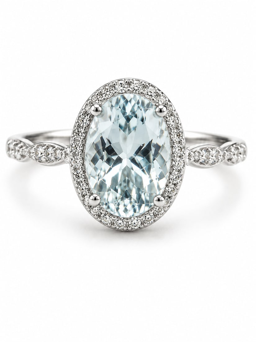 Sterling Aquamarine & CZ Halo Ring: 925 sterling silver ring featuring a large oval-cut aquamarine centerpiece surrounded by a halo of sparkling CZ accents. The band features an elegant twisted design with additional CZ detailing along 