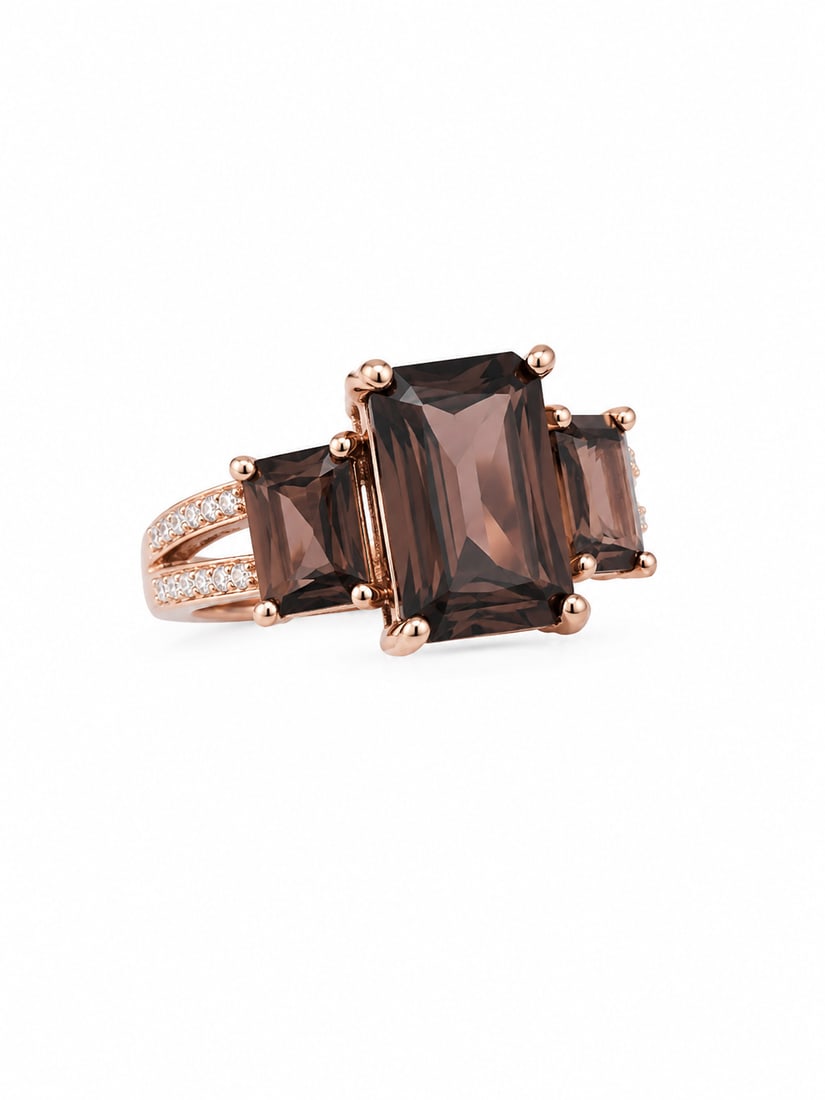 Sterling Smoky Quartz Three-Stone Rose Gold Ring: 925 sterling silver ring with a rose gold finish, featuring a three-stone arrangement of emerald-cut smoky quartz. A large center stone is flanked by two coordinating smoky quartz stones, with sparkli