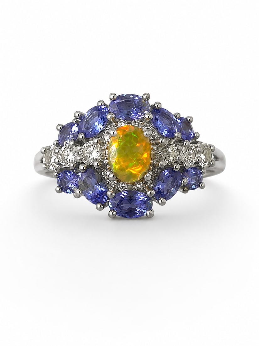 Opal & Tanzanite 925 Sterling Silver Cluster Ring: Sterling silver statement ring featuring a vivid oval opal center with fiery yellow, orange, and green flashes, surrounded by an ornate cluster of oval-cut tanzanite and sparkling white accent stones.