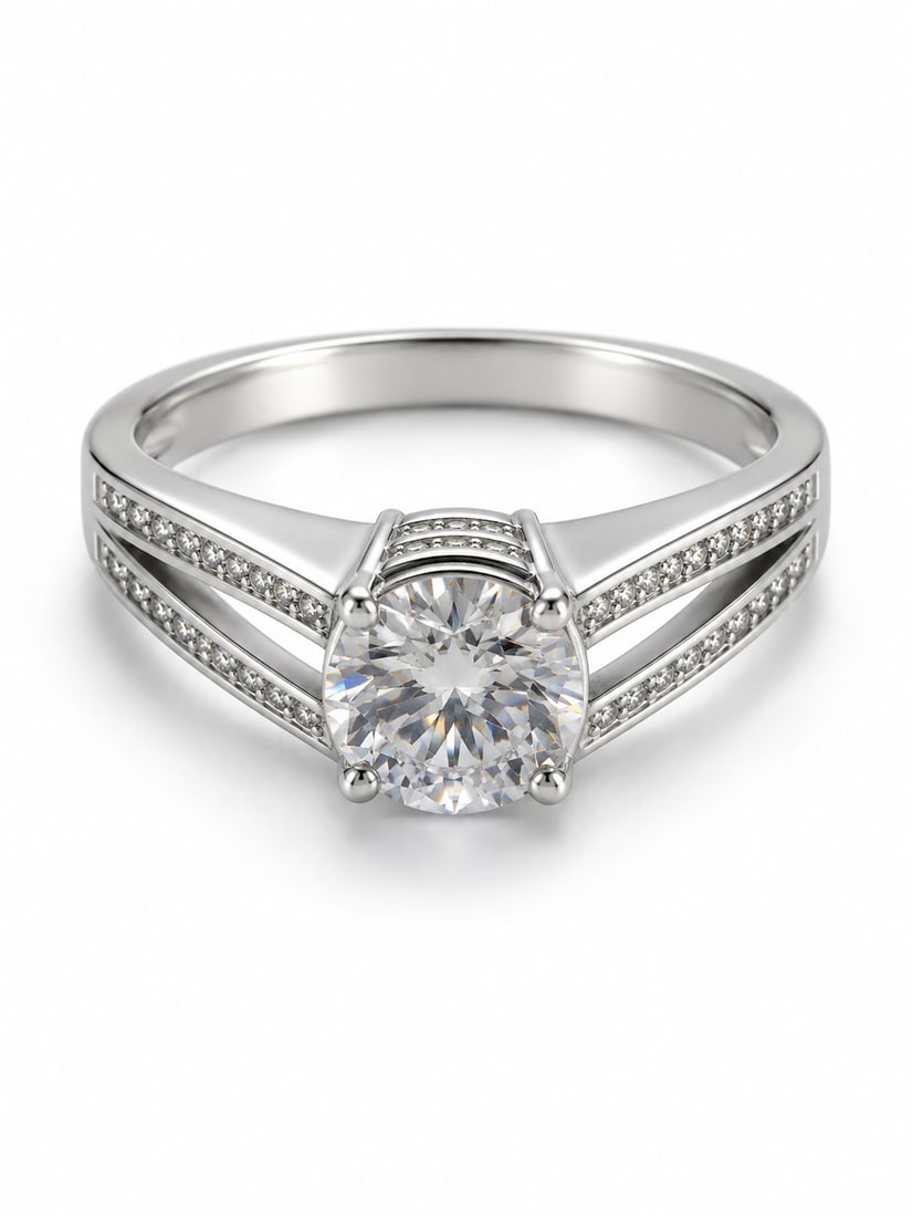 Round CZ Solitaire 925 Sterling Silver Split Shank Ring: Sterling silver ring featuring a brilliant round-cut cubic zirconia center stone in a four-prong setting. The split shank is accented with rows of smaller CZ stones, creating an elegant engagement-ins