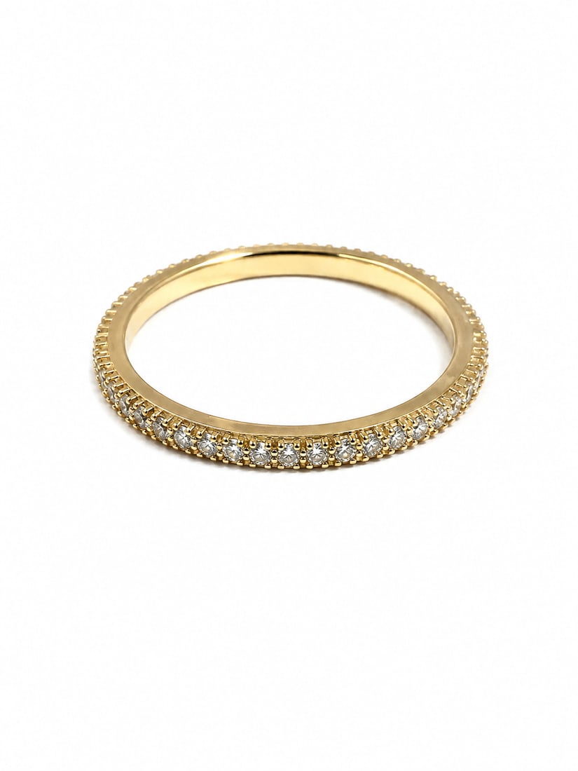 925 Sterling Gold CZ Eternity Band Ring: Gold 925 sterling ring featuring a classic eternity-band design set with a continuous row of sparkling round cubic zirconia. Slim, elegant profile with a timeless look that works beautifully alone or 