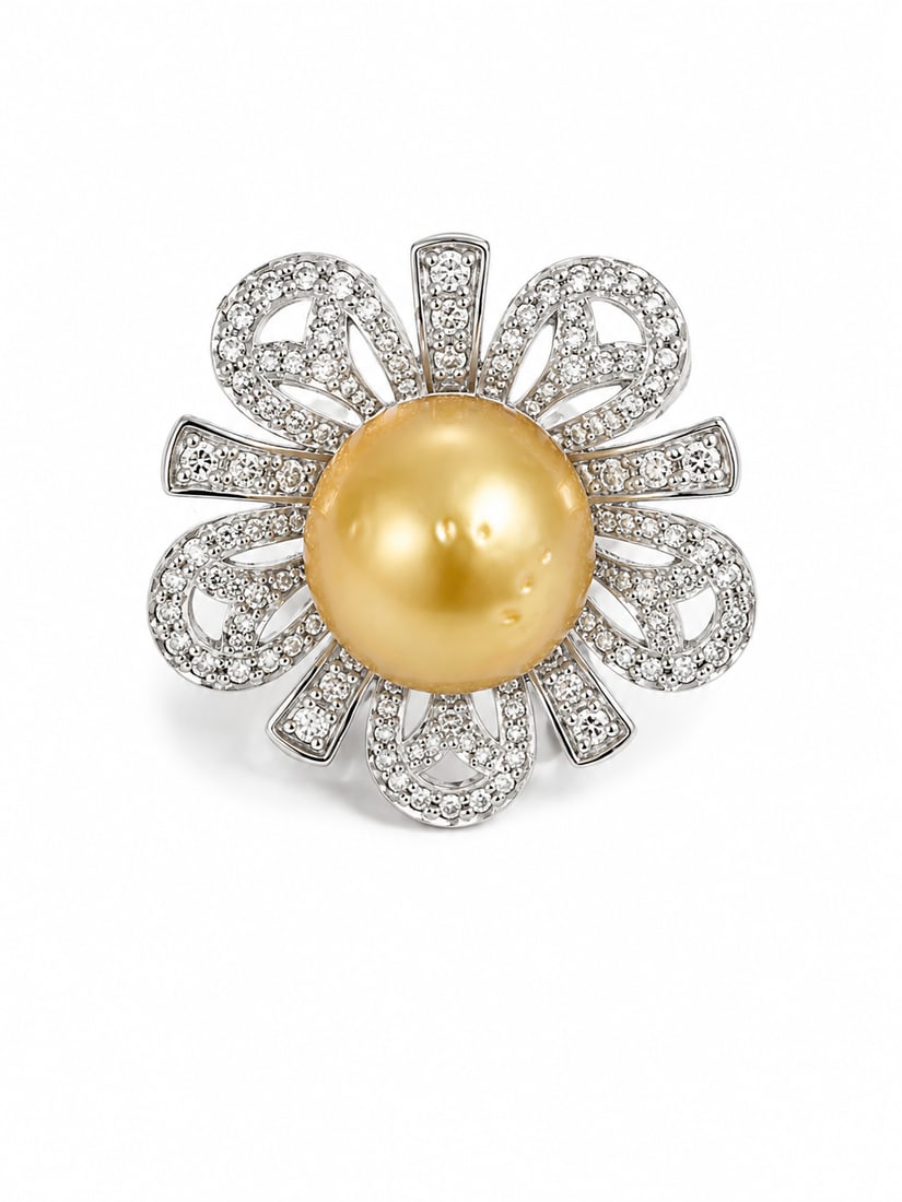 Golden Pearl & Crystal Floral Statement Ring: Elegant statement ring featuring a large golden pearl centerpiece surrounded by an ornate flower design. The sculptural petals are covered in sparkling crystal accents, creating a bold floral