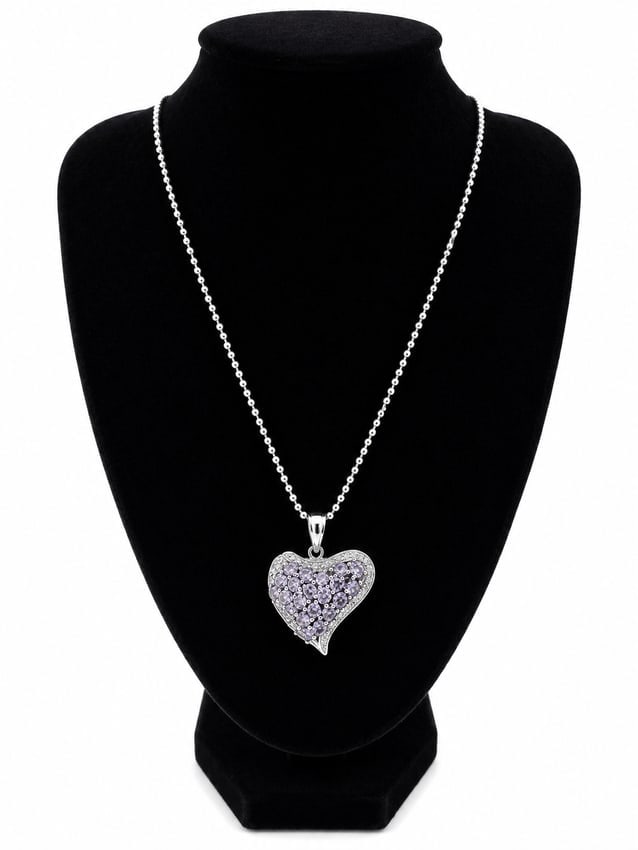 Heart Pendant Necklace with Violet Stones: Heart-shaped pendant necklace featuring round purple-colored stones and clear accent stones. Ships from Newport Beach, CA. Proceeds go to Hoag Hospital Charitable Foundation Previous Lot: 103