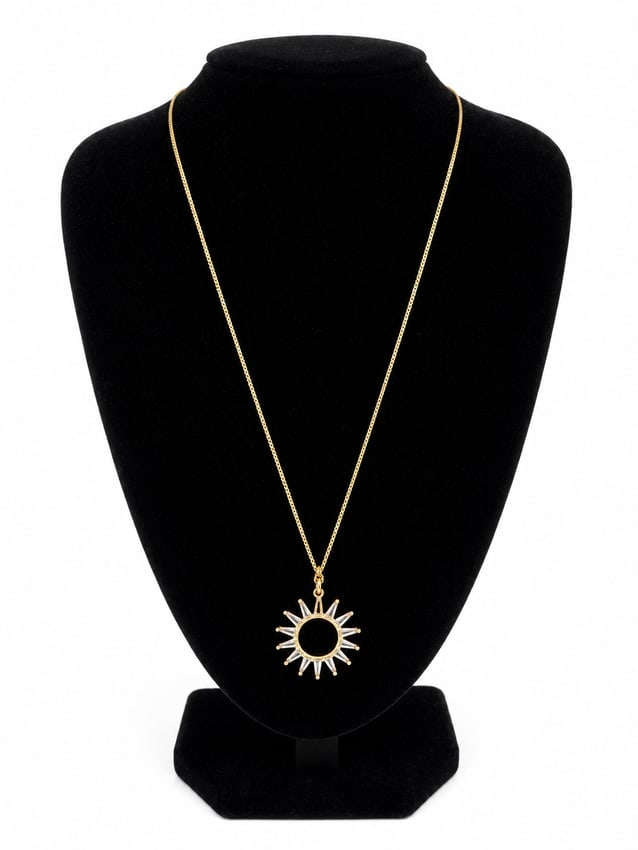 Gold Sunburst Pendant Necklace: Gold chain necklace featuring a sunburst-style pendant with clear baguette-style stones and a dark center. Ships from Newport Beach, CA.Proceeds go to Hoag Hospital Charitable Foundation. Previous
