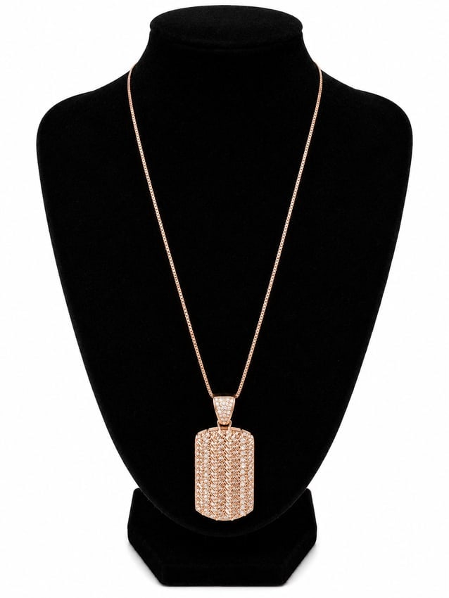 Rose Gold Dog Tag Pendant Necklace: Rose gold necklace featuring a rectangular dog tag-style pendant with textured detailing and clear stone accents throughout the pendant and bail. Ships from Newport Beach, CA. Previous Lot: 310