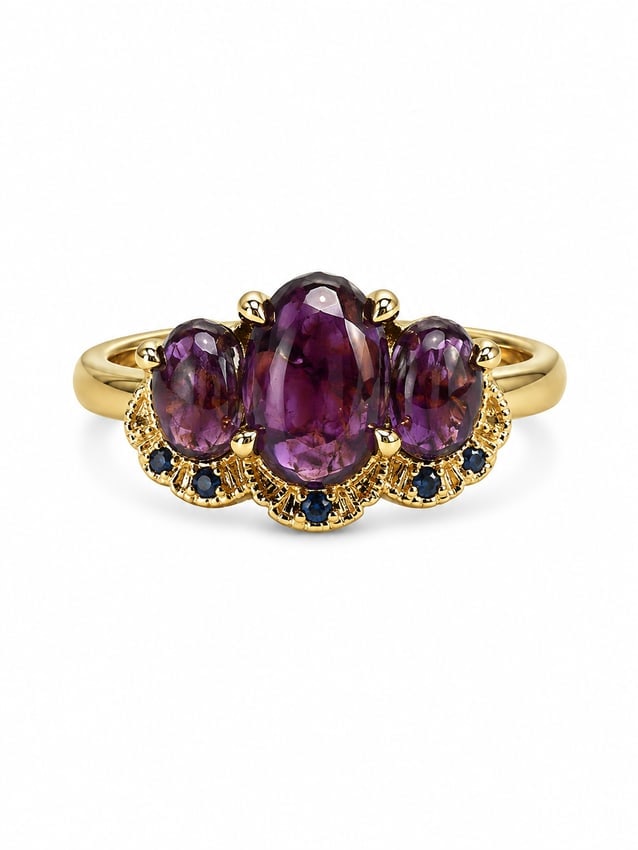 Gold Ring with Amethyst Oval Stones & Blue Accent Stones: Gold ring featuring three oval purple stones with an amethystnappearance, accented by smaller deep blue stones along the lower setting. Ring size 8. Ships from Newport Beach, CA. Previous Lot: 316