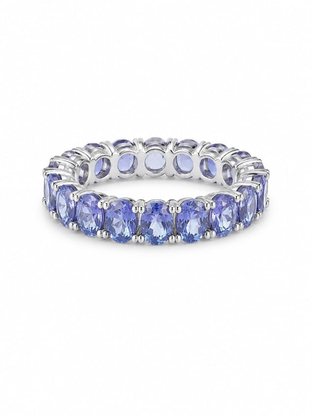 Sterling Eternity Style Ring with Oval Lavender Blue Stones: Silver ring featuring a continuous row of oval lavender-blue stones set around the band in an eternity style design. Size 9. Ships from Newport Beach, CA. Previous Lot: 334