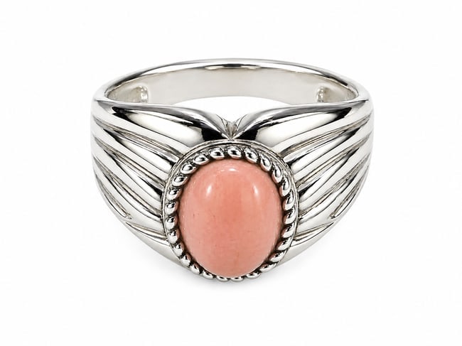 Sterling Ring with Pink Opal Oval Cabochon: Sterling silver ring featuring a smooth oval pink cabochon with an opal appearance, framed by rope-style detailing. The shoulders feature sculpted wing-inspired detailing. Stamped “925” for st