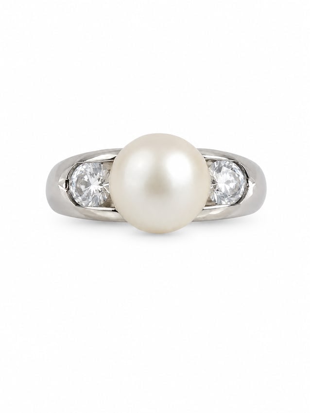 Sterling Pearl & Clear Stone Ring: sterling silver ring featuring a large white pearl center accented by two round clear stones, one on each side. The polished silver band has a sleek, open setting that highlights the center pearl and 