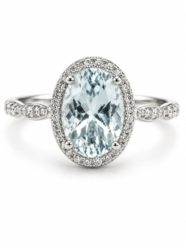 Sterling Aquamarine & CZ Halo Ring: 925 sterling silver ring featuring a large oval-cut aquamarine centerpiece surrounded by a halo of sparkling CZ accents. The band features an elegant twisted design with additional CZ detailing along 