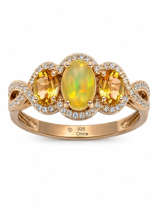 Fire Opal & Citrine 925 Sterling Silver Gold Ring: Gold ring featuring a vibrant oval fire opal center stone with glowing yellow, orange, and green flashes, flanked by two oval-cut golden citrine stones. Sparkling CZ halo accents surround the gemstone