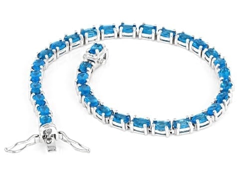 6.27ctw Neon Apatite Tennis Bracelet in Rhodium-Plated Sterling Silver: 6.27ctw Neon Apatite Tennis Bracelet A striking 6.27ctw continuous line of electric neon apatite, set in polished rhodium over sterling silver. Ships from Newport Beach, C