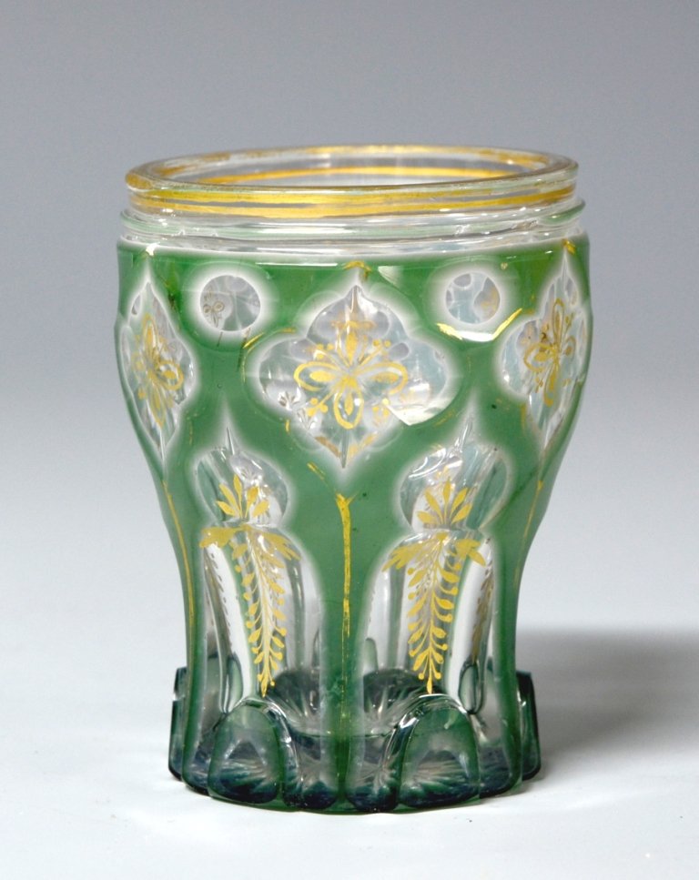 Double Overlay Glass Beaker: Green over white over clear with decorative facet-cuts to clear. 16 point star-cut base. Gilded floral decoration over facet-cuts and on body. 3.3"ht., Bohemian, circa 1860.