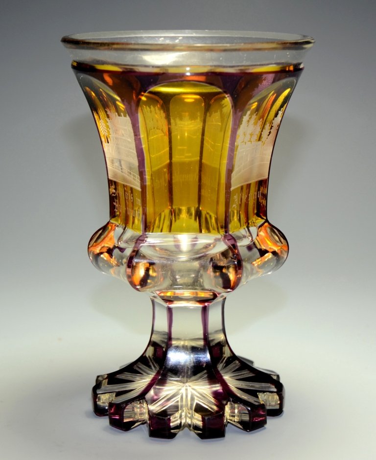Overlay Beaker: Amethyst over clear glass. Six facet-cuts to bowl and foot. Amber stained panels with engraved building scenes. 6.75"ht., Bohemian, circa 1860.